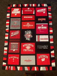 a quilt made to look like the wisconsin badgers football team is displayed on a table