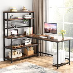 a computer desk sitting in front of a window next to a bookshelf filled with books