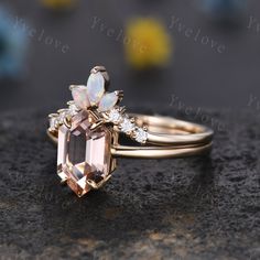 an image of a ring set with opal and diamonds on the top, sitting on a rock