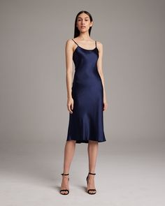 Bias cut silk charmeuse midi slipdress elegantly drapes on the body. This perfect basic can be worn for life, dressed up, or dressed down, for the perfect effortless ensemble. Style with a sweater and boots in the Fall or wear with sandals in the Summer. 100% Silk Charmeuse Made in New York City Product Care: Dry Clean Only Knee-length Silk Evening Dress, Classic Silk Dress For Date Night, Chic Fitted Silk Knee-length Dress, Elegant Mid-length Mini Dress For Daywear, Chic Fitted Knee-length Silk Dress, Fitted Knee-length Silk Dress For Date Night, Elegant Knee-length Fitted Slip Dress, Sleek Fitted Slip Dress For Daywear, Elegant Midi Slip Dress For Fall