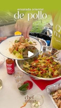 a person serving food from a platter on top of a table