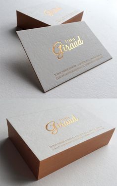 two business cards with gold foil lettering on them, one is white and the other is brown