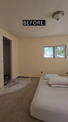 an empty bedroom with white sheets on the bed and windows in the room that have been painted