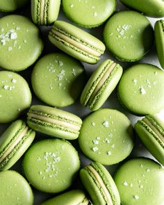 green macaroons with white sprinkles on them