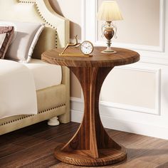 a small wooden table with a clock on it's side next to a bed