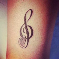 a musical note with a heart tattoo on the arm and foot is shown in black ink