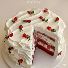 there is a cake with white frosting and strawberries on the top it has one slice cut out