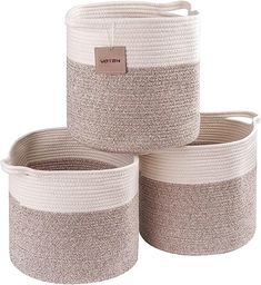 three white and grey baskets with handles on each side, one has a brown tag hanging from the top