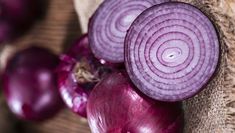 some onions are laying next to each other on a cloth and burlied sack