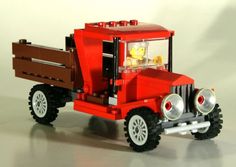 a lego truck with a yellow duck in the cab and some black wheels on it