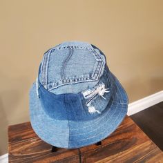 a blue jean hat sitting on top of a wooden table