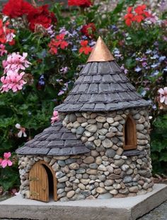 a small house made out of rocks and wood