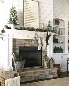 a living room with a fire place and christmas stockings on the mantel above it