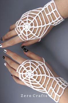 two hands with white crocheted lace on them and black nail polishes in the middle