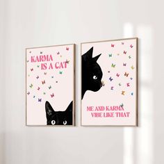 two black cats are hanging on the wall