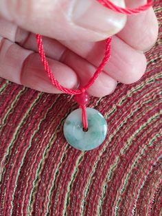 This pendant is made of 100%       Green Jade. Hand carved 20*20       mm Jade Safety Button.  It's a       Original color and high quality.        Hand made Red color Necklace.        with 6 mm Red Jade bead.  Jade safety Button is one of the.        most popular pendant in China .       When you driving or traveling       You need wear the Jade pendant.  Necklace is a adjustable. Green Round Disc Necklace For Gift, Green Amulet Round Necklace, Green Round Amulet Necklace, Green Amulet Style Round Necklace, Buddha Hand, Jade Buddha, Jade Pendant Necklace, Red Jade, Carved Jade