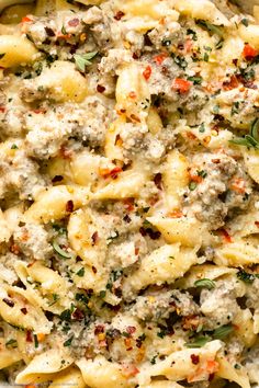 pasta with meat, cheese and herbs in a casserole dish ready to be eaten