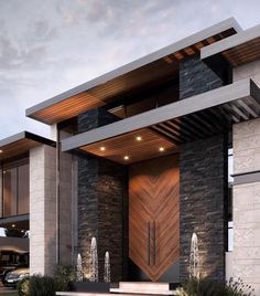 the front entrance to a modern house with stone and wood accents, along with steps leading up to it