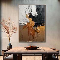 an abstract painting hangs on the wall above a dining room table