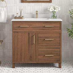 a bathroom with a sink, mirror and towel rack on the wall next to it