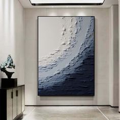 an abstract painting hangs in the middle of a room