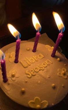 a birthday cake with lit candles on it