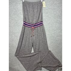 Comfy And Stylish Gray Jumpsuit With A Playful Beaded Belt. Ideal For Those Days When You Want To Look Chic Without Trying Too Hard. Size: M/L Brand: Lucky Brand Materials: Polyester, Cotton Color: Gray Elastic Waist Colorful Elastic Belt Detail Wide Leg Fit Easy Care Measurements Laying Flat Armpit To Armpit: 14" - Will Stretch It Is Elastic Waist: 15 Inches Across The Front Inseam: 32 Inches Size: Womens M/L Condition: New With Tags Summer Strapless Jumpsuit With Elastic Waistband For Loungewear, Casual Strapless Sleeveless Jumpsuit With Elastic Waistband, Casual Strapless Jumpsuit With Elastic Waistband, Casual Strapless Jumpsuit With Elastic Waistband For Vacation, Casual Stretch Strapless Jumpsuit For Beach, Casual Strapless Overall Jumpsuit For Beach, Bohemian Jumpsuits And Rompers With Elastic Waistband, White Halter Jumpsuit, Gray Jumpsuit