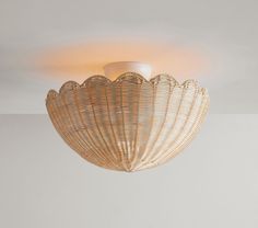 a light that is hanging from the ceiling in a room with white walls and flooring