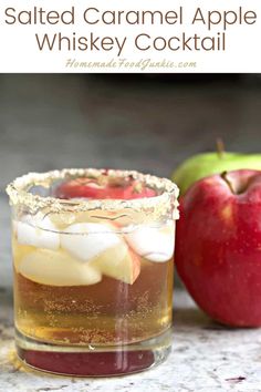 an apple cider is served in a glass with ice