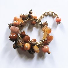 A variety of materials in warm neutral tones make for a one-of-a-kind, chunky charm-style bracelet.  Glass, agate, plastic, stone, and even a bit of wood beads add a punch of bold to any upscale casual look. Great alone or mixed with your favorite pieces, this bracelet plays well with others and elevates even the most basic of ensembles.   Adjustable  with a lobster clasp, it comfortably fits most wrist sizes. Made with an eclectic mix of beads upcycled from pre-owned jewelry, it's a more sustai Neutral Bracelet, Neutral Bracelets, Upscale Casual, Brown Bracelet, Bracelet Beaded, Neutral Tones, Bead Bracelet, Fast Fashion, Wood Beads