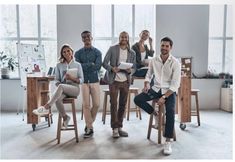 group of people sitting around a table in an office