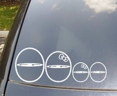 the stickers on the side of a car are depicting four circles with an apple in them