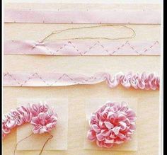 some pink flowers are sitting on top of white papers with string attached to the sides