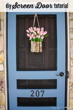 a blue front door with some flowers hanging from it's side and the words diy screen door tutor