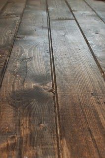 an old wooden table with some paint peeling off the top and wood grain on the bottom