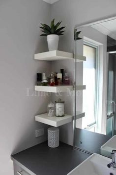 a white sink sitting under a bathroom mirror next to a shelf filled with personal care items