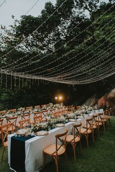 a long table set up for an outdoor dinner