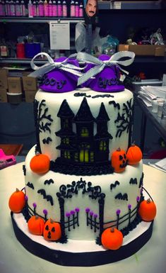 a three tiered cake decorated with halloween decorations