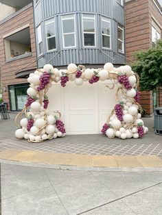 an arch made out of balloons and grapes