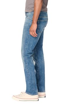 A distressed medium wash renders a laid-back vibe in a pair of slim-fit jeans that effortlessly retain their shape while also offering stretch. Zip fly with button closure Five-pocket style 92% cotton, 7% polyester, 1% Lycra® spandex Machine wash, dry flat Imported Distressed Fitted Medium Wash Jeans, Distressed Fitted Jeans In Medium Wash, Casual Slim Fit Jeans With Button Closure, Fitted Distressed Jeans For Everyday Wear, Everyday Fitted Distressed Jeans, Rugged Straight Leg Bottoms For Everyday, Rugged Fitted Straight Leg Jeans, Rugged Medium Wash Bottoms With Standard Cut Leg, Rugged Washed Blue Straight Leg Jeans