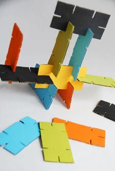 an abstract sculpture made out of colored cardboard