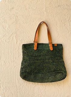 These gorgeous handwoven totes are designed and produced in Cape Town, South Africa.  Each piece is composed from sun dried raffia and leather. Please note some will be a deep moss green while others may appear more emerald- as they are all hand dyed variations may occur Eco-friendly Crochet Jute Bag With Woven Leather, Eco-friendly Crochet Bag With Woven Leather Details, Eco-friendly Jute Crochet Bag With Woven Leather, Green Rectangular Jute Shoulder Bag, Eco-friendly Green Jute Shoulder Bag, Green Woven Crochet Rectangular Bag, Eco-friendly Crochet Bag With Woven Leather, Handwoven Green Crochet Beach Bag, Green Jute Crochet Bag For Daily Use