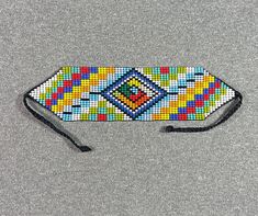 a colorful beaded headband on a gray surface