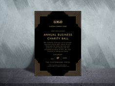 a black and gold business card with the words annual business charity ball written on it