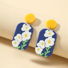 Beautiful lightweight earrings with a stud post. Length: 1.5inches Width: 1 inch Trendy White Drop Clip-on Earrings, Trendy White Drop Earrings, Trendy Single White Earring, Trendy White Single Earring, Trendy White Pierced Earrings, Studio Blue, Blue Daisy, Daisy Earrings, Light Weight Earrings