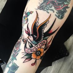 a woman's arm with tattoos on it and a bird in the middle of her arm