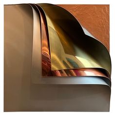 an abstract metal sculpture is shown against a brown wall with gold and silver foil on it