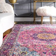 a colorful area rug in front of a gray wall