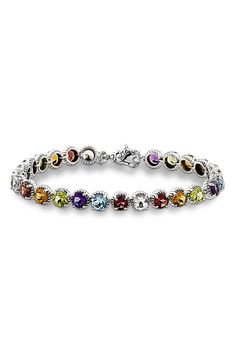 Round-cut multicolored stones are prong-set along this timeless tennis bracelet. 7 1/4" inner circumference; 1" width Total stone weight: 14.49ct. Sterling silver/rhodolite/blue topaz/amethyst/peridot/citrine/garnet/white topaz Imported Silver Multi-stone Tennis Bracelet, Fine Jewelry Multicolor Cubic Zirconia Tennis Bracelet, Multicolor Cubic Zirconia Tennis Bracelet For Anniversary, Multi-stone Tennis Bracelet In Fine Jewelry Style, Multicolor Cubic Zirconia Tennis Bracelet For Formal Occasions, Formal Multi-stone Cubic Zirconia Tennis Bracelet, Multicolor Cubic Zirconia Tennis Bracelet With Multi-stone, Multicolor Multi-stone Cubic Zirconia Tennis Bracelet, Multicolor Gemstone Tennis Bracelet