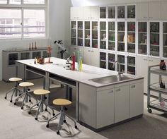 a kitchen with lots of counter space and stools